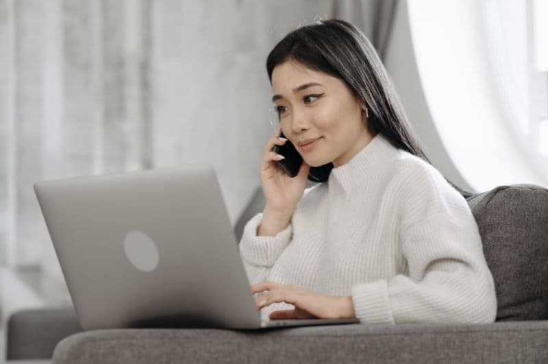 Woman on laptop looking at real estate listings